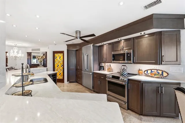 a living room with furniture large window and wooden floor