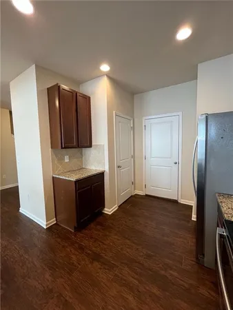 a large kitchen with a refrigerator and a stove top oven