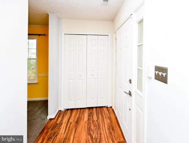 a kitchen with cabinets and wooden floor