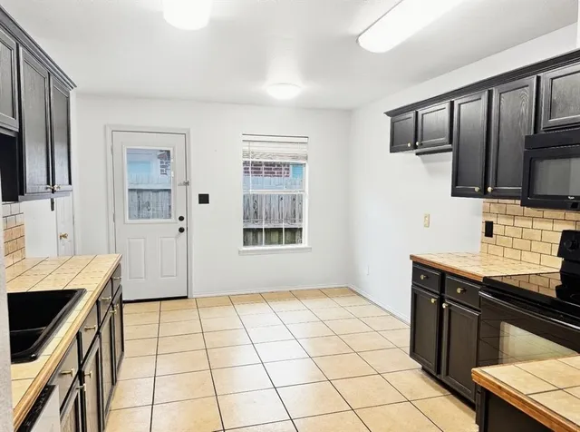 a kitchen with stainless steel appliances a sink stove and refrigerator