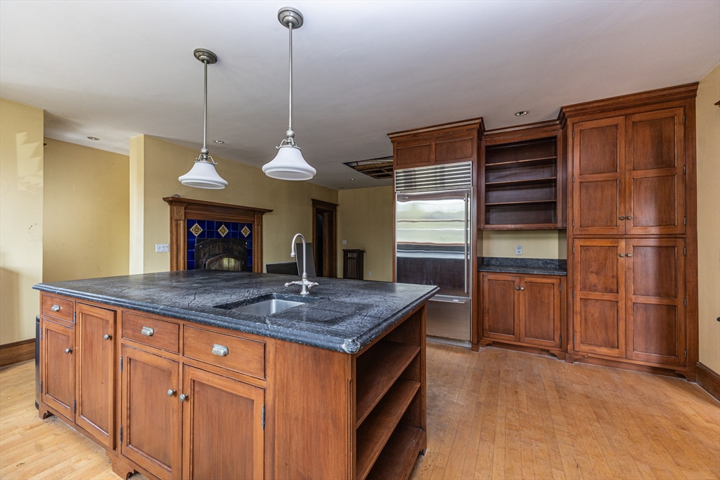 29 Gorham Street Chelmsford, MA 01824 - Photo 12 of 42 a kitchen with stainless steel appliances granite countertop a sink refrigerator and cabinets