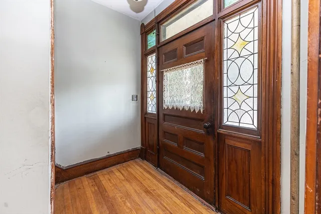 a view of an empty room and wooden floor