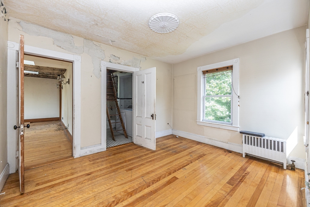 29 Gorham Street Chelmsford, MA 01824 - Photo 28 of 42 an empty room with wooden floor and windows