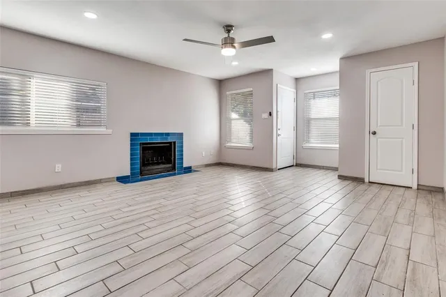 a view of a livingroom with wooden floor and a ceiling fan window