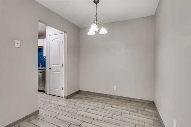 a view of a chandelier fan and wooden floor