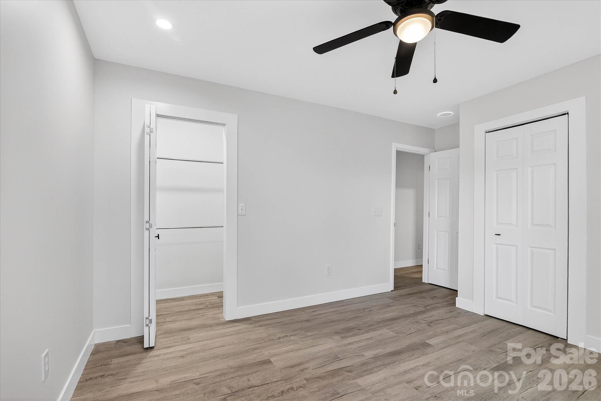 817 Mable Avenue Kannapolis, NC 28083 - Photo 12 of 20 an empty room with wooden floor closet and fan