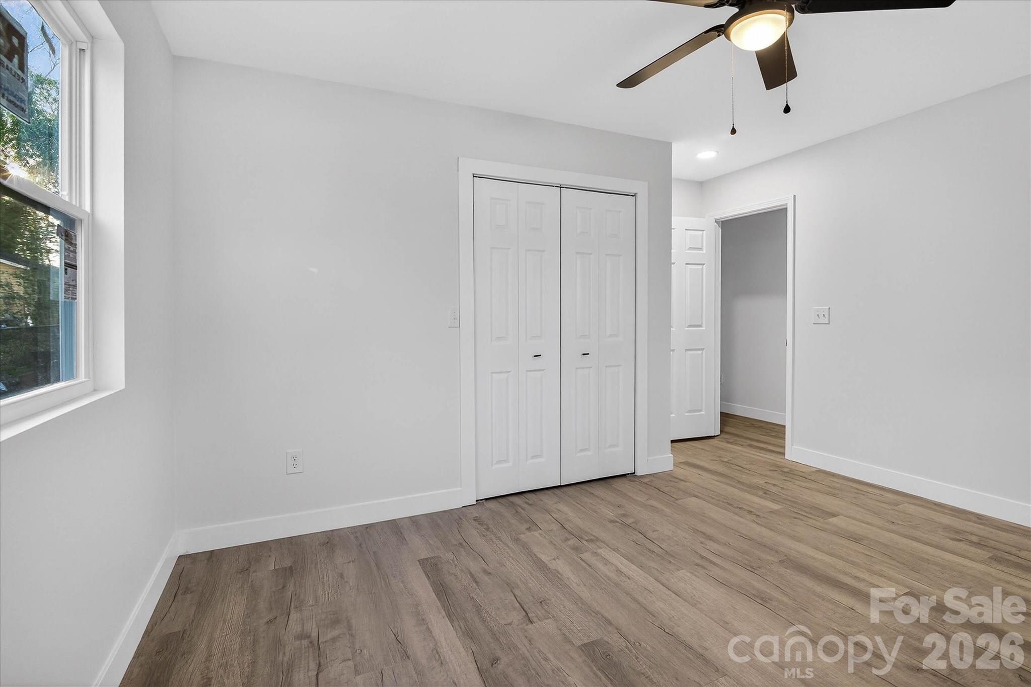 817 Mable Avenue Kannapolis, NC 28083 - Photo 13 of 20 a view of an empty room with wooden floor and a window