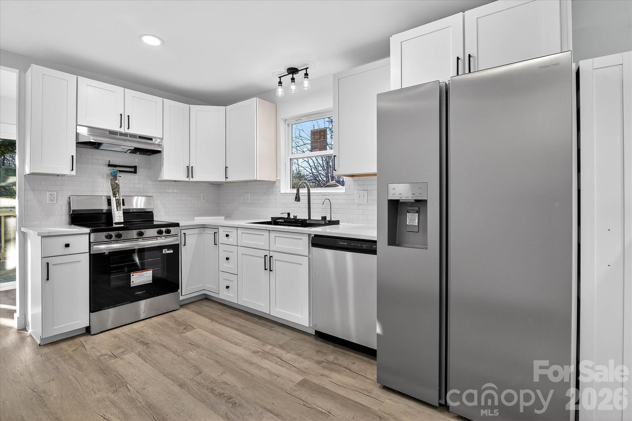 817 Mable Avenue Kannapolis, NC 28083 - Photo 5 of 20 a kitchen with stainless steel appliances a refrigerator sink and stove
