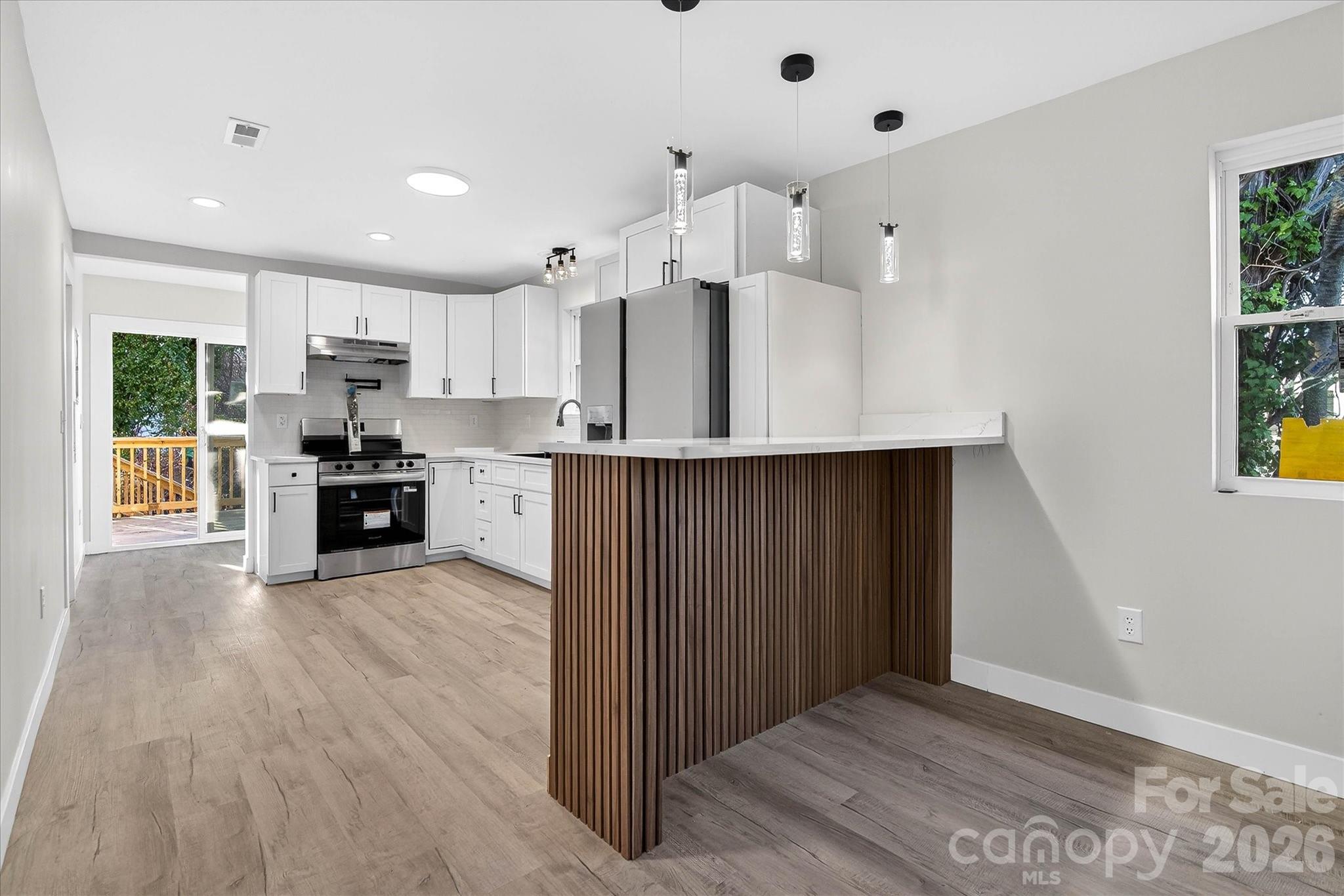 817 Mable Avenue Kannapolis, NC 28083 - Photo 6 of 20 a kitchen with stainless steel appliances a refrigerator and a wooden floor