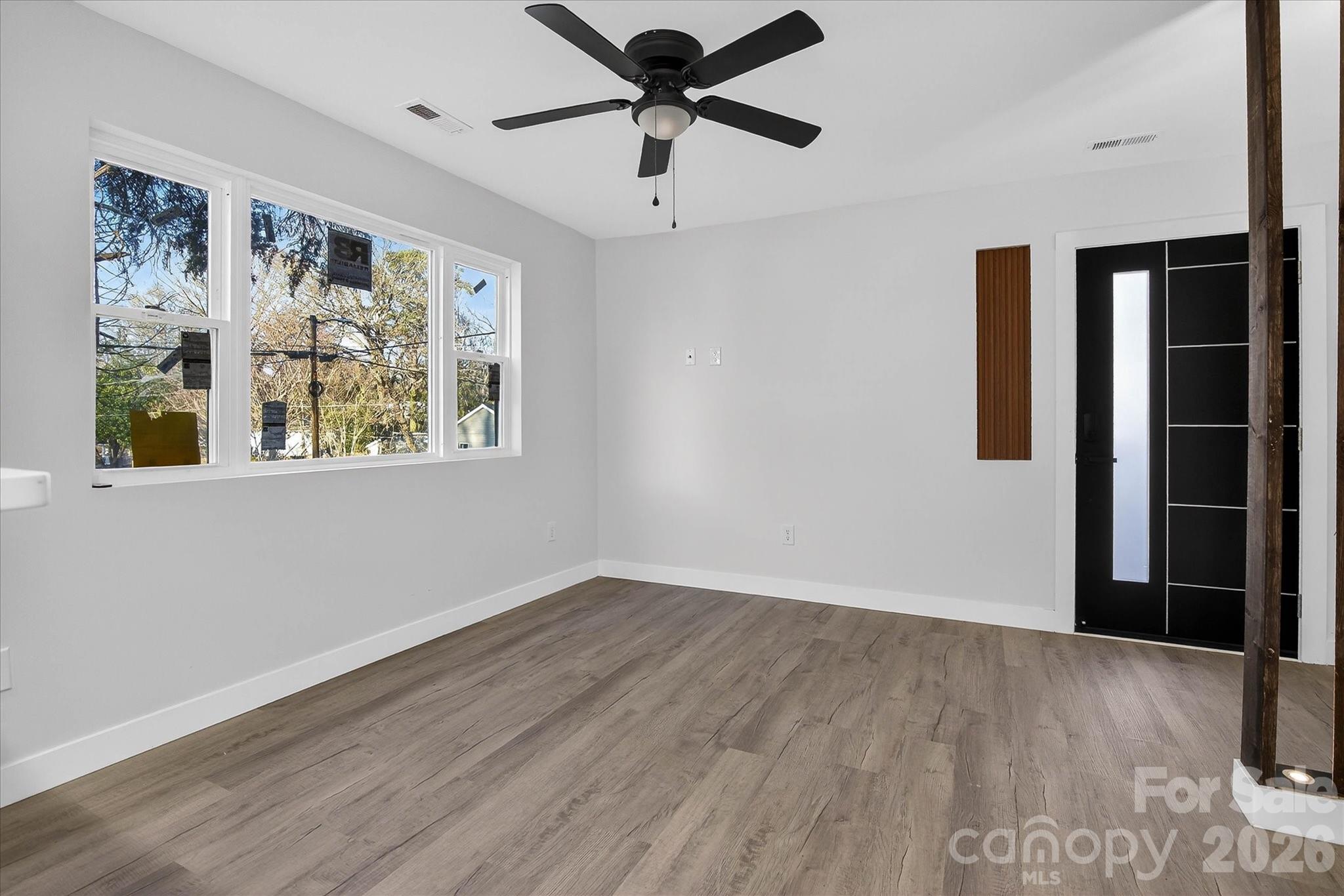 817 Mable Avenue Kannapolis, NC 28083 - Photo 7 of 20 a view of an empty room with a window and wooden floor