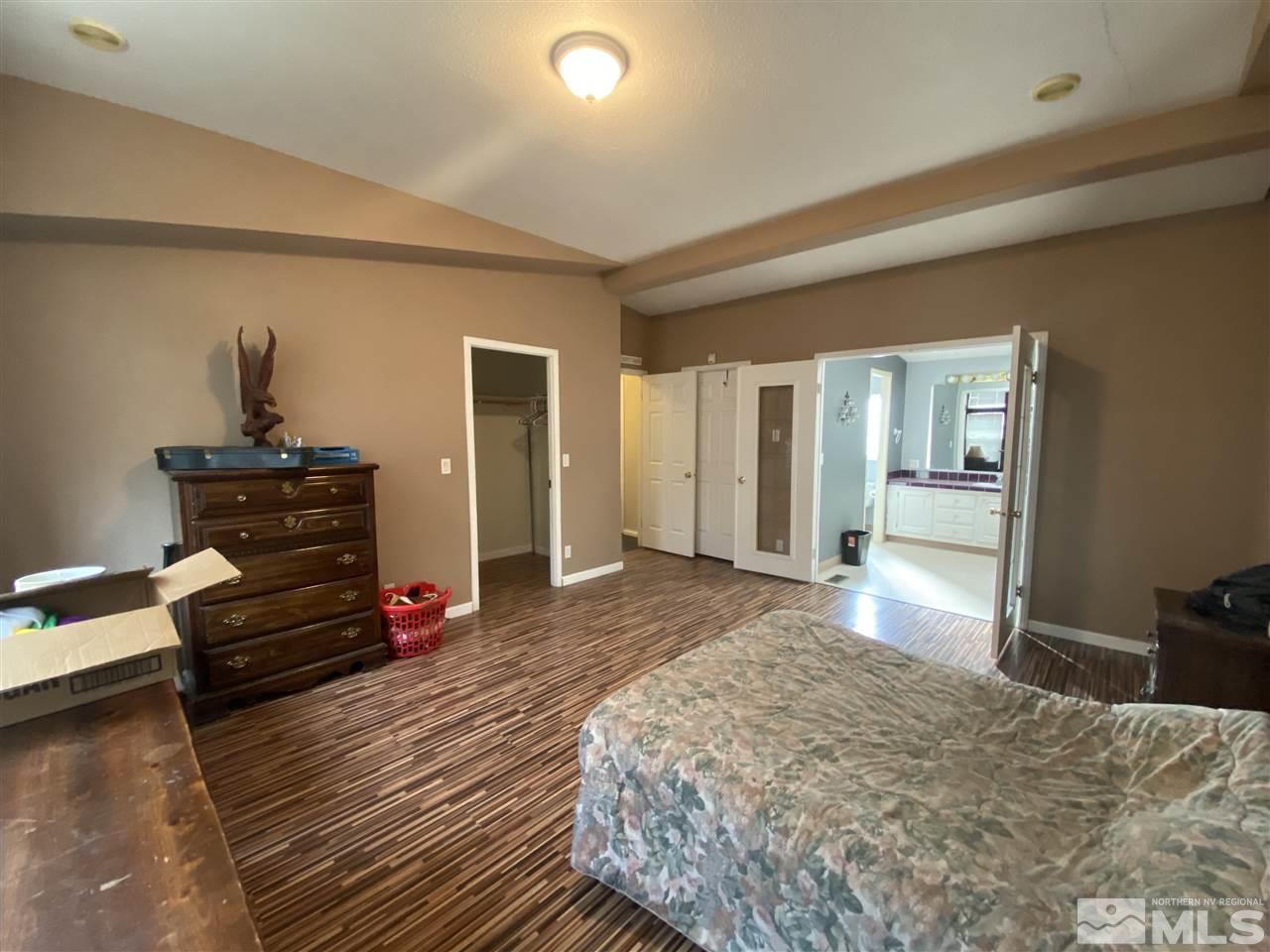 1660 Rockchuck Road Reno, NV 89506 - Photo 9 of 15 a bedroom with a bed and wooden floor