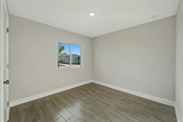 a view of a house with a big yard and palm trees