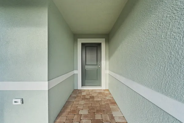 a kitchen with a sink a counter and chandelier