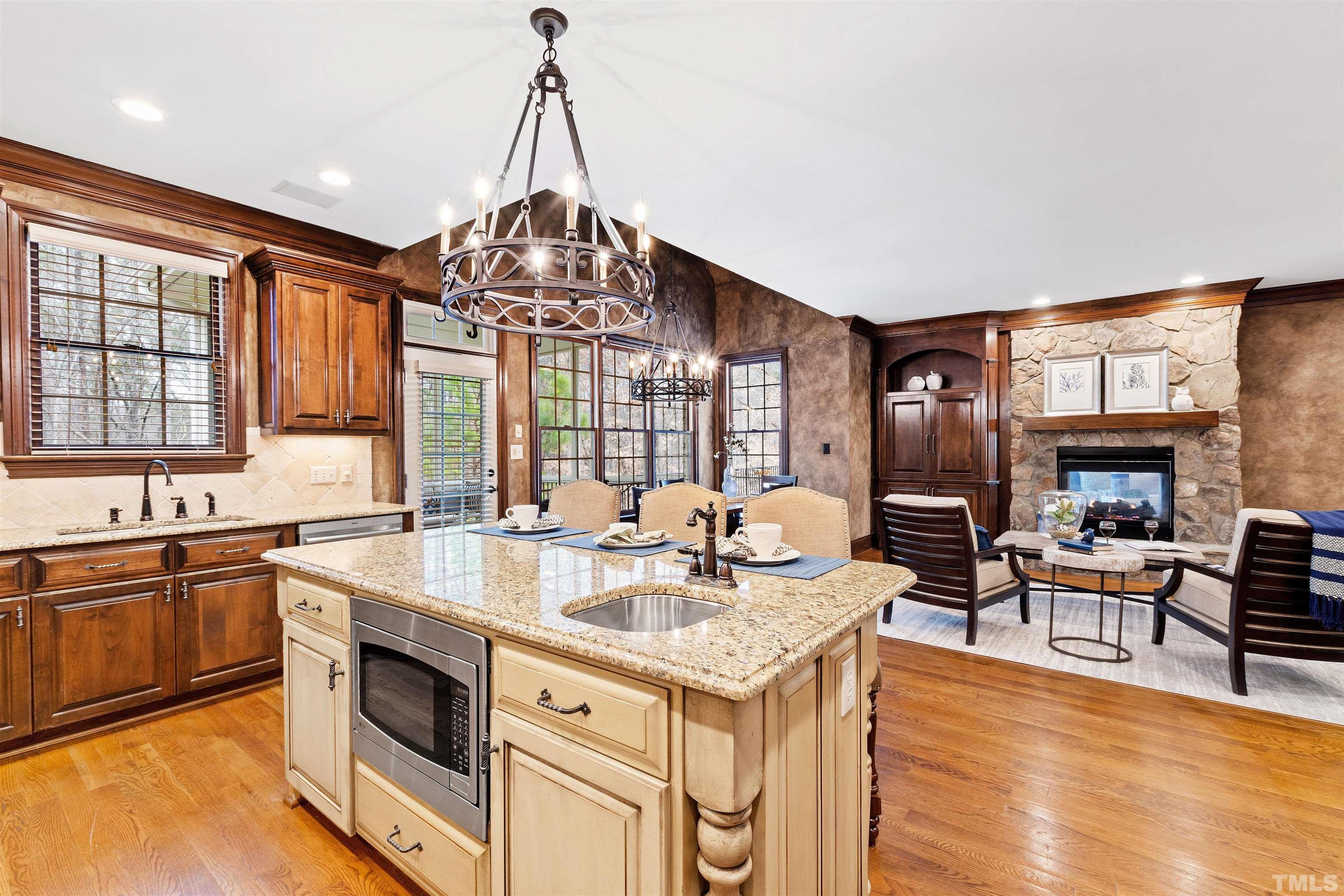 1313 Caistor Lane Raleigh, NC 27614 - Photo 12 of 84 a kitchen with granite countertop a sink stove and cabinets