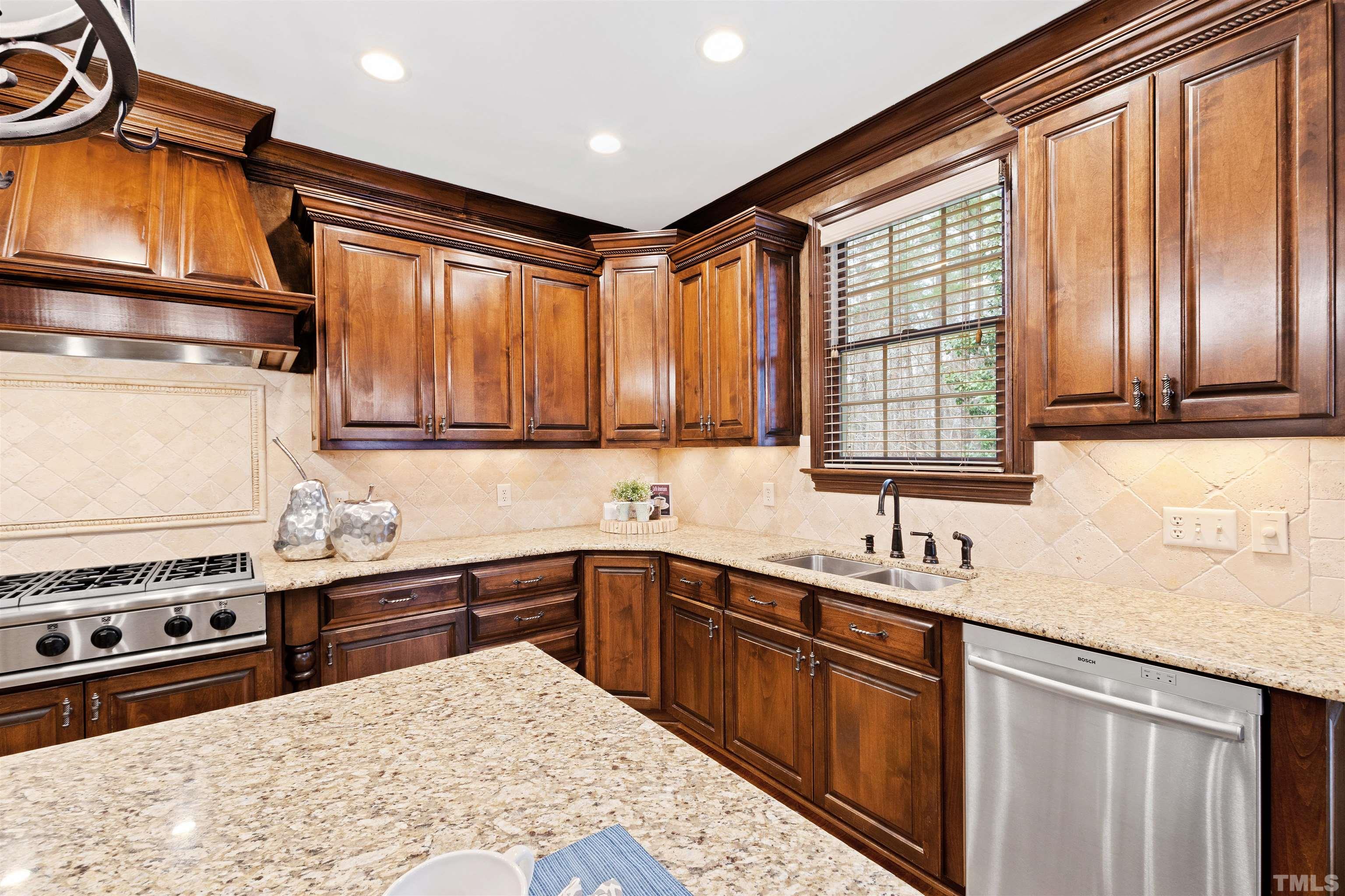 1313 Caistor Lane Raleigh, NC 27614 - Photo 17 of 84 a kitchen with stainless steel appliances granite countertop a sink stove and refrigerator