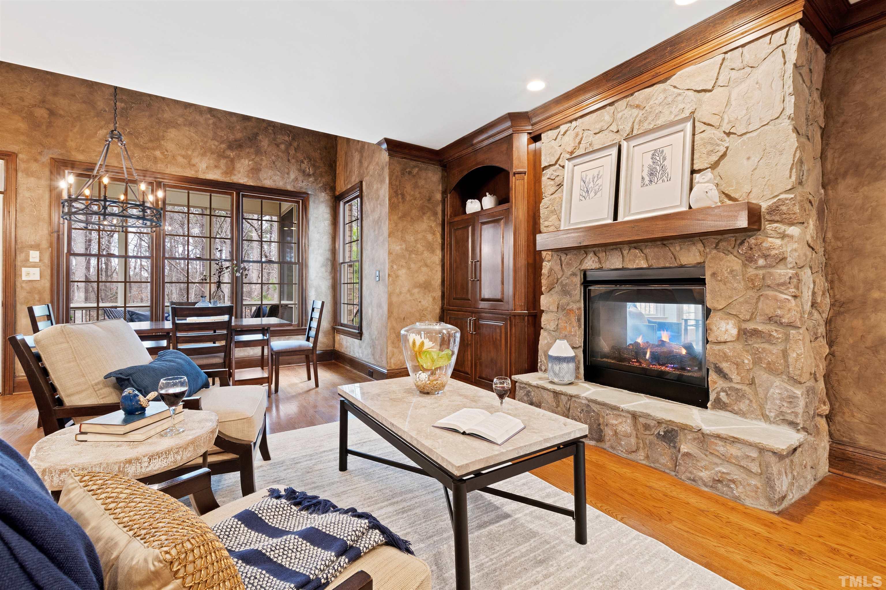 1313 Caistor Lane Raleigh, NC 27614 - Photo 21 of 84 a living room with furniture a fireplace and a floor to ceiling window
