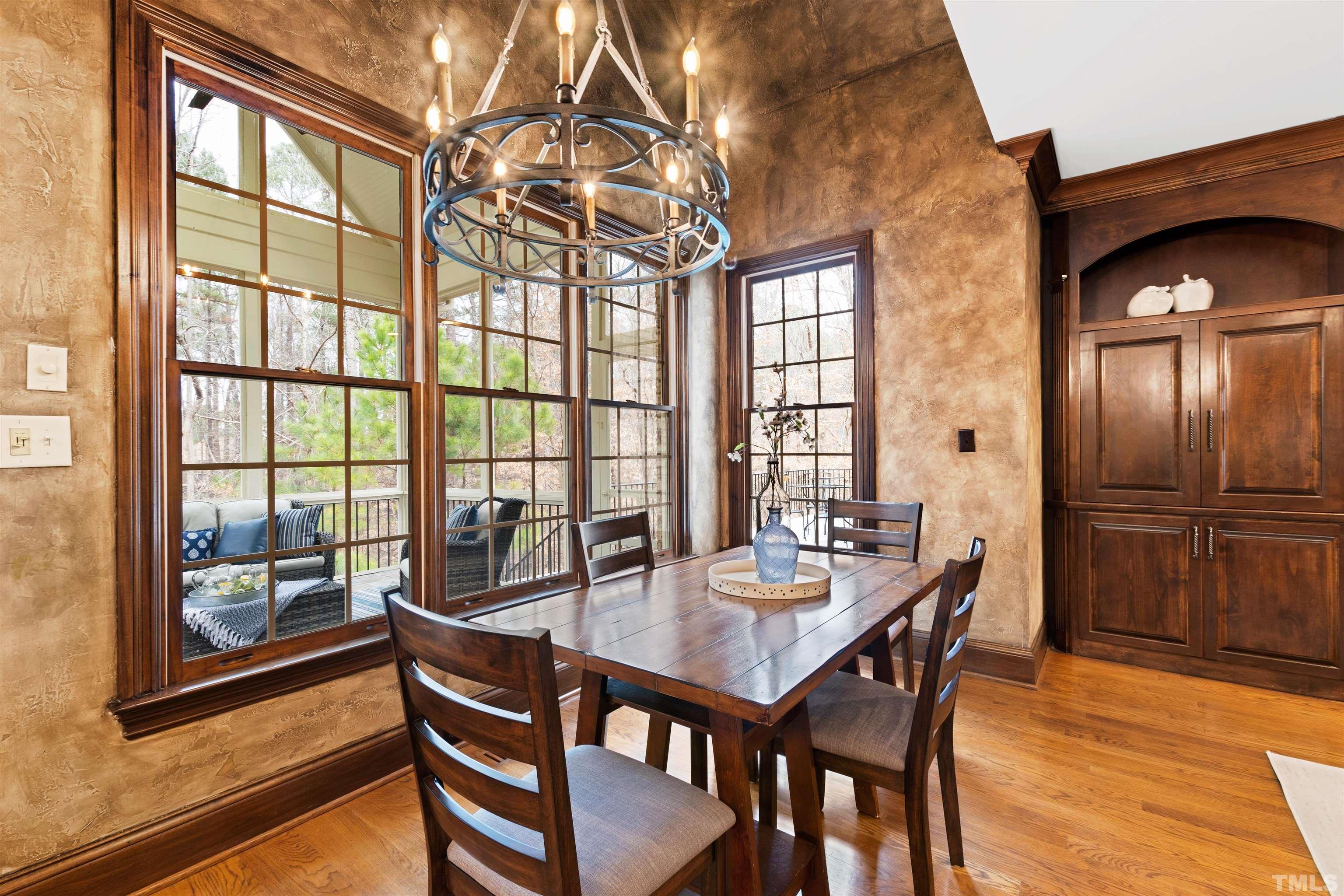 1313 Caistor Lane Raleigh, NC 27614 - Photo 25 of 84 a dining room with furniture a chandelier and wooden floor