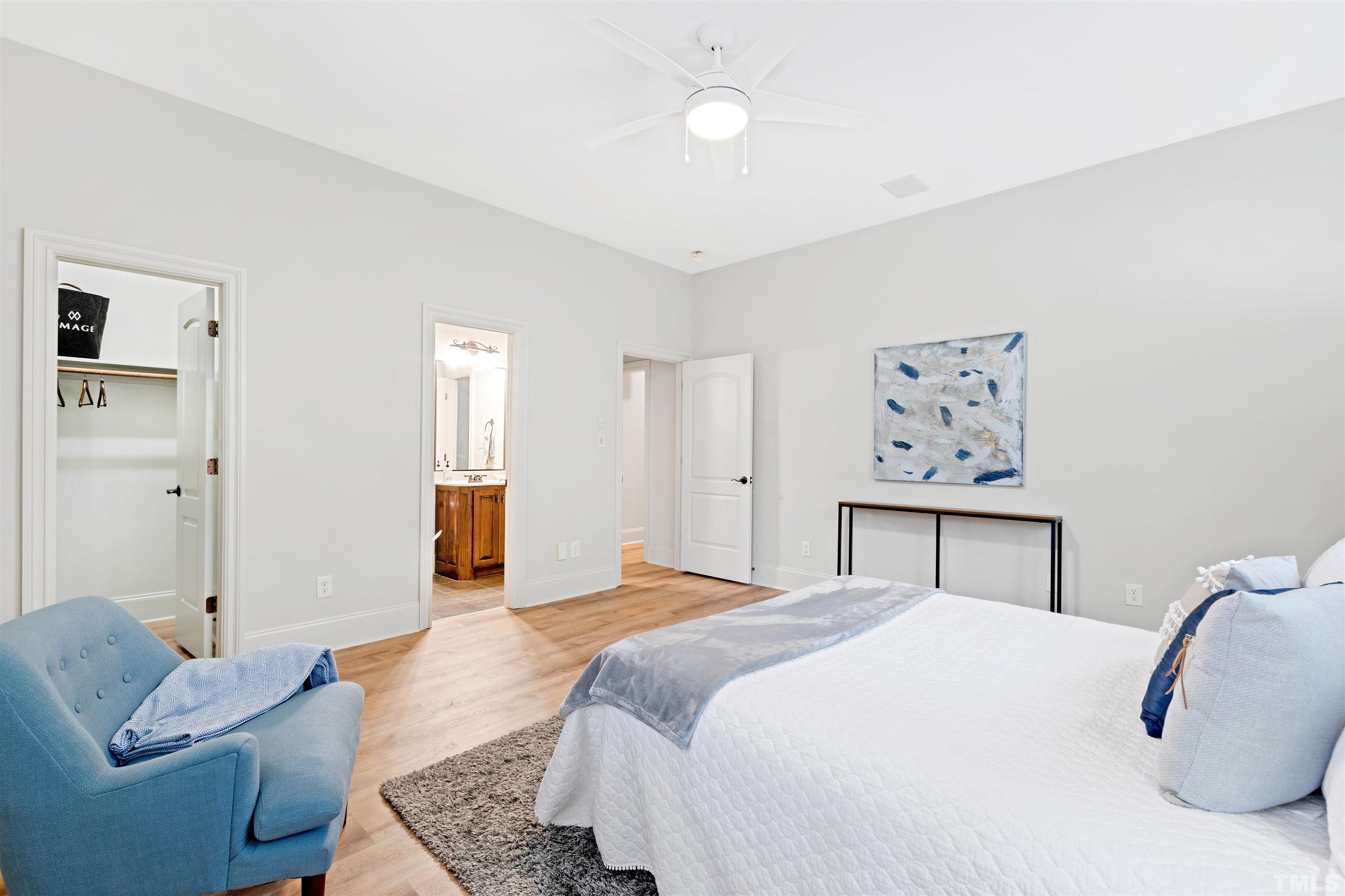 1313 Caistor Lane Raleigh, NC 27614 - Photo 50 of 84 a bedroom with a bed and wooden floor