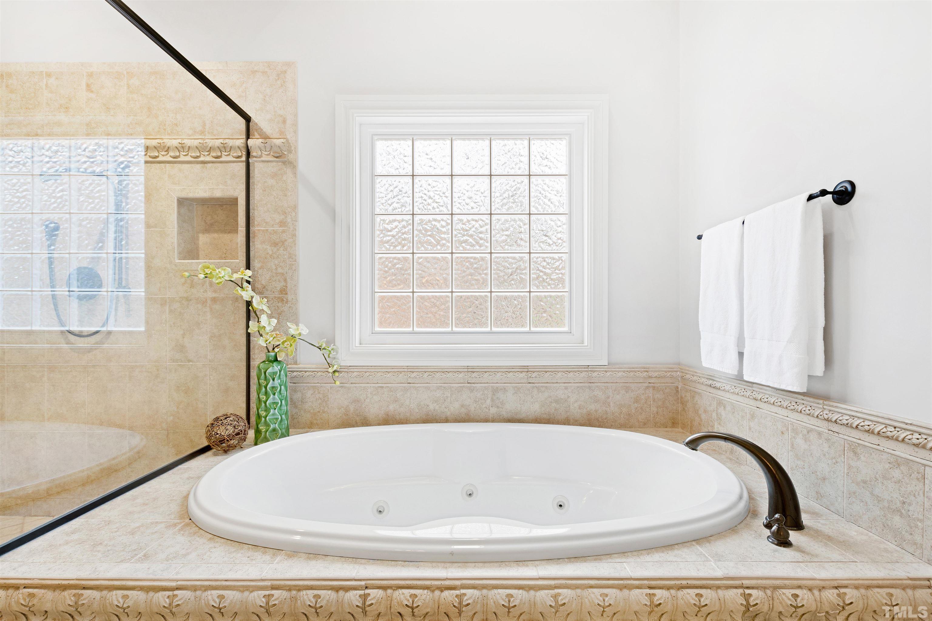 1313 Caistor Lane Raleigh, NC 27614 - Photo 56 of 84 a bathroom with bathtub and window