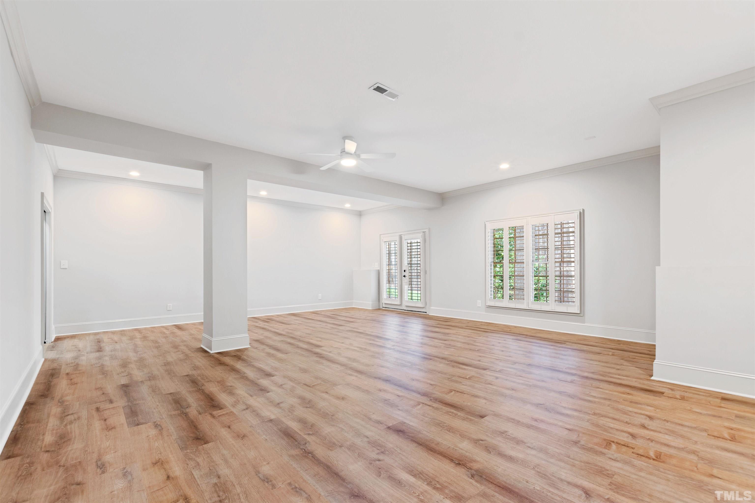 1313 Caistor Lane Raleigh, NC 27614 - Photo 67 of 84 a view of an empty room with wooden floor and a window