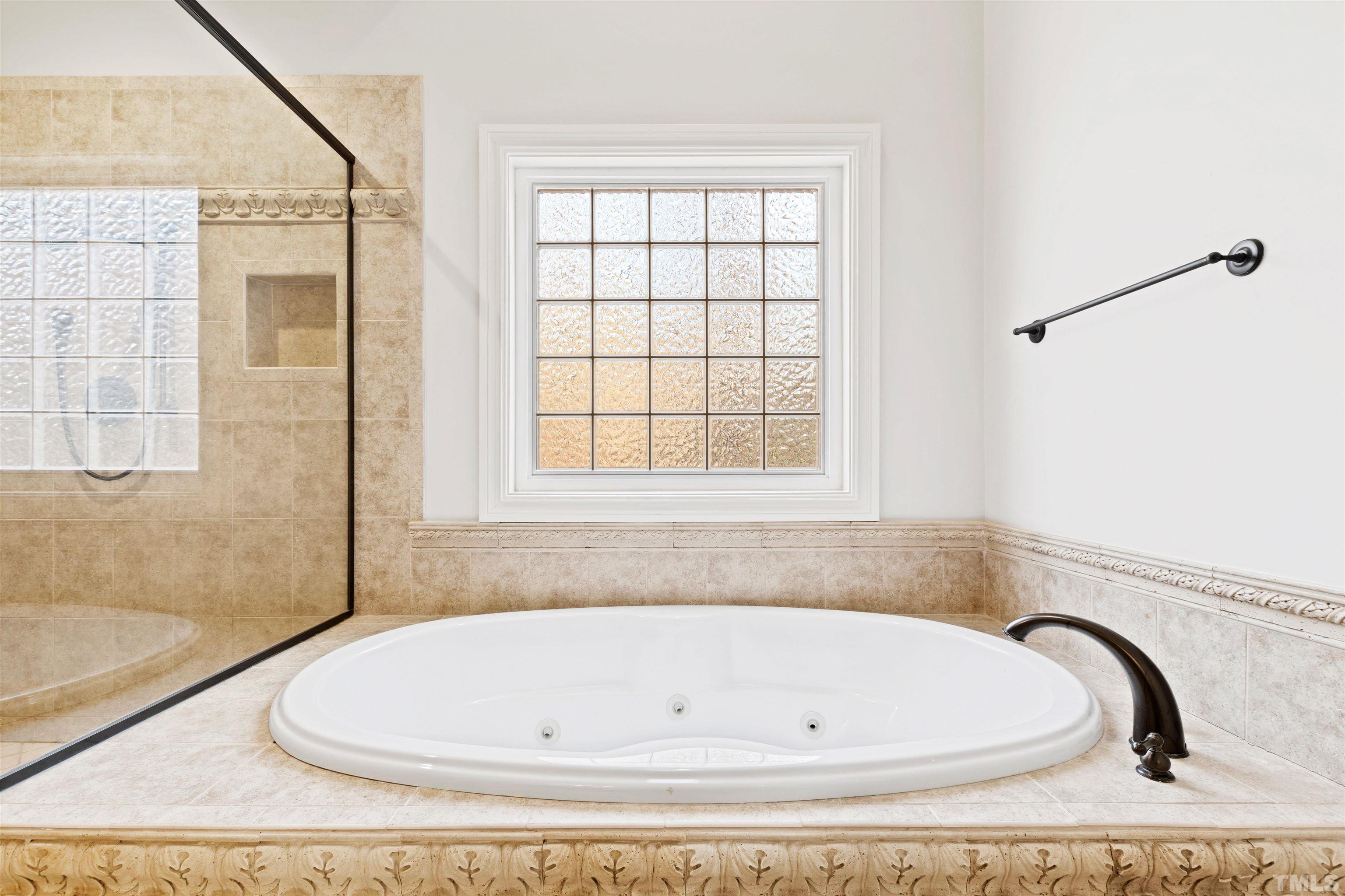 1313 Caistor Lane Raleigh, NC 27614 - Photo 70 of 84 a white bath tub sitting in a bathroom next to a window