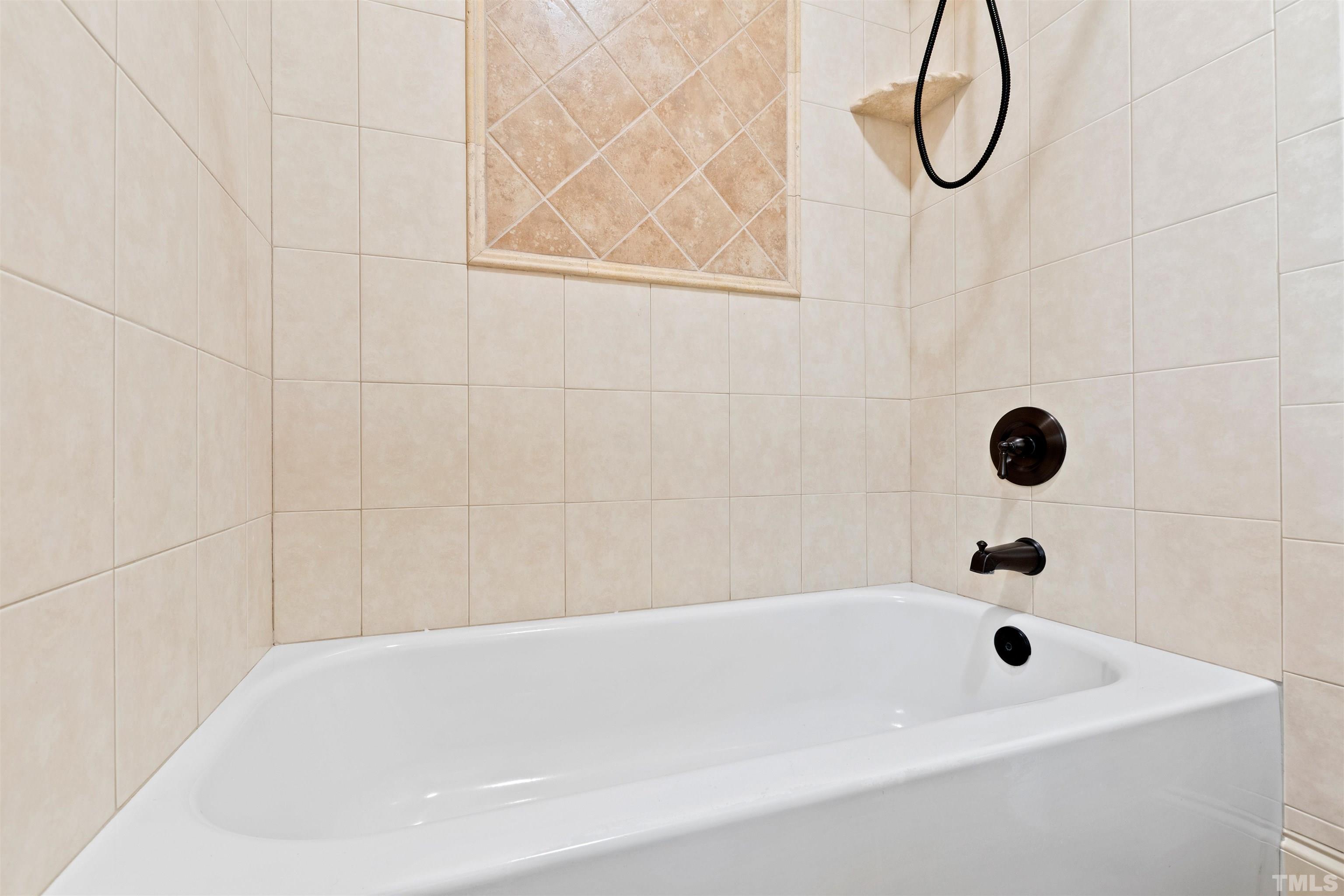 1313 Caistor Lane Raleigh, NC 27614 - Photo 72 of 84 a bathroom with a bath tub with a shower