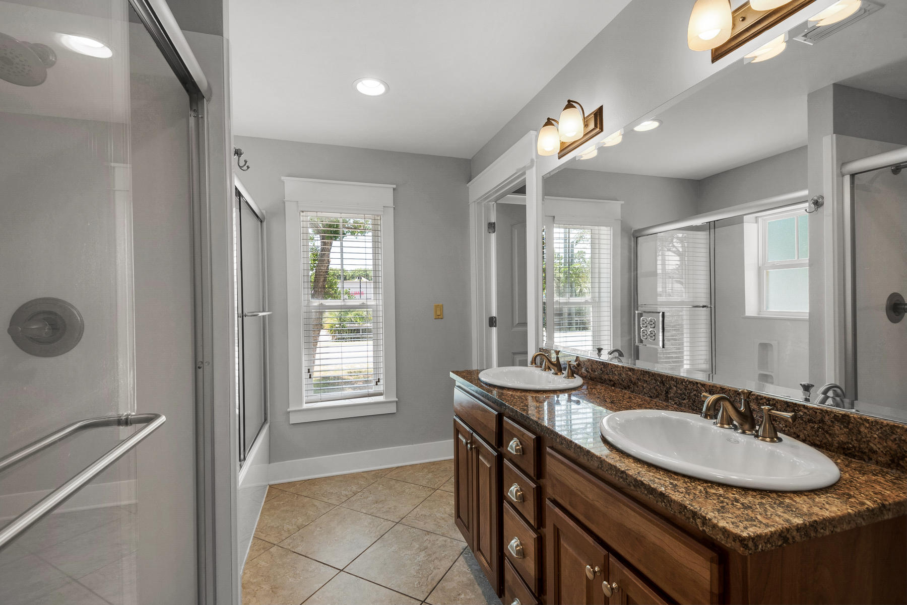 15 Seaspring Cove Santa Rosa Beach, FL 32459 - Photo 14 of 43 a bathroom with a granite countertop sink a large mirror and a shower