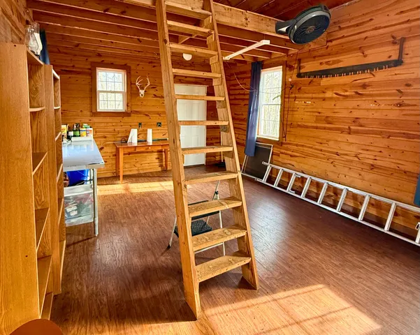 a view of a living room with wooden floor