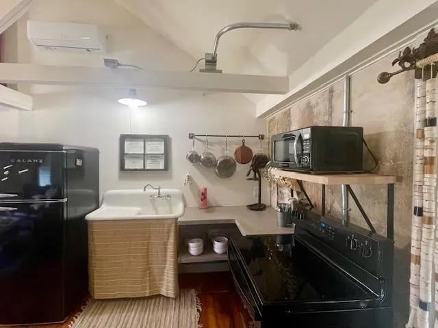 a kitchen with a sink appliances and cabinets