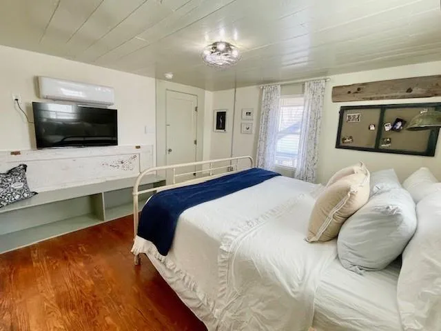 a bedroom with a bed and a flat screen tv