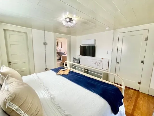 a bedroom with a bed and a flat screen tv