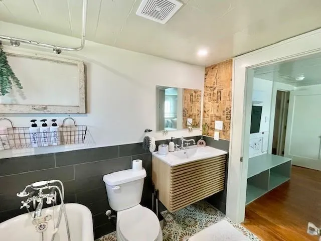 a bathroom with a toilet sink and mirror