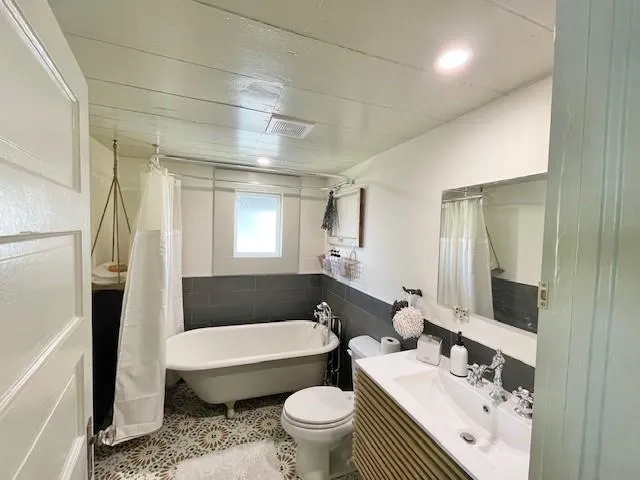 a bathroom with a sink a toilet and a mirror