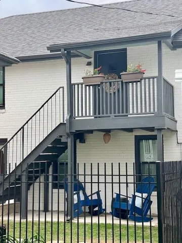 a view of a brick house with a deck
