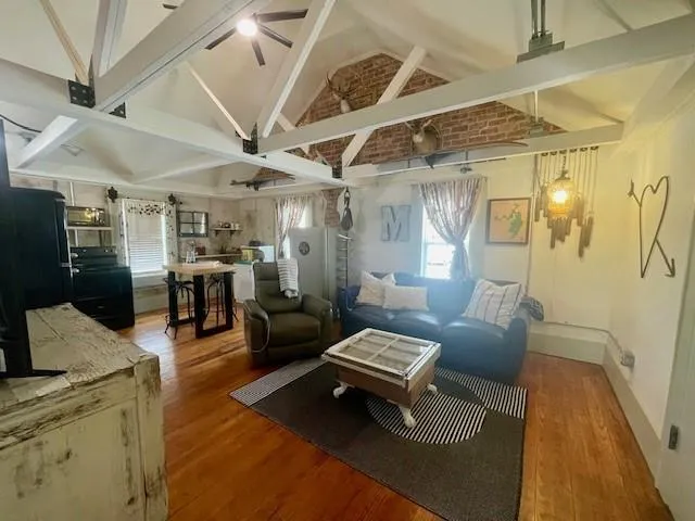 a living room with furniture and wooden floor