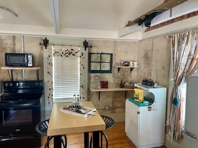 302 East Shoemaker Street Decatur, TX 76234 - Photo 8 of 21 a kitchen with a table chairs and a refrigerator