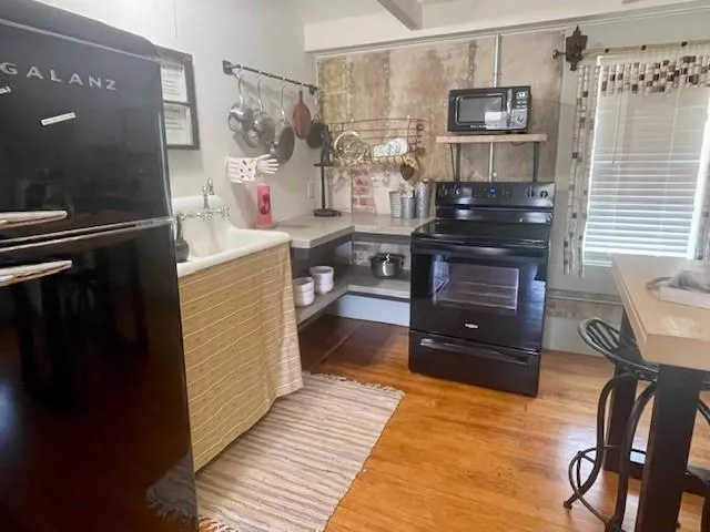 a kitchen with stainless steel appliances granite countertop a sink and wooden cabinets
