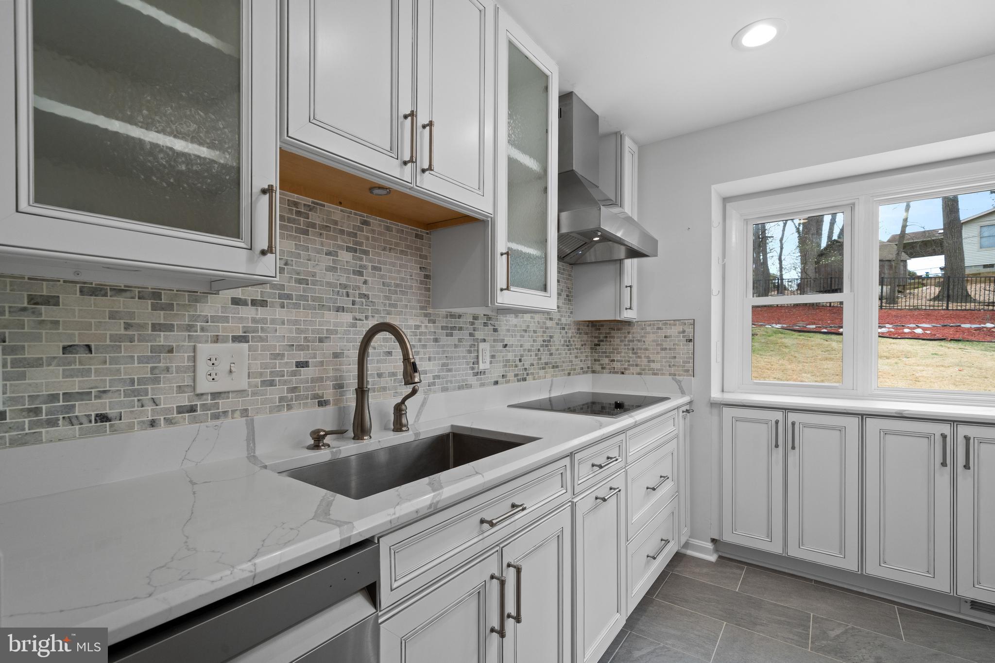 6119 Greeley Boulevard Springfield, VA 22152 - Photo 11 of 38 a kitchen with stainless steel appliances granite countertop white cabinets and a sink