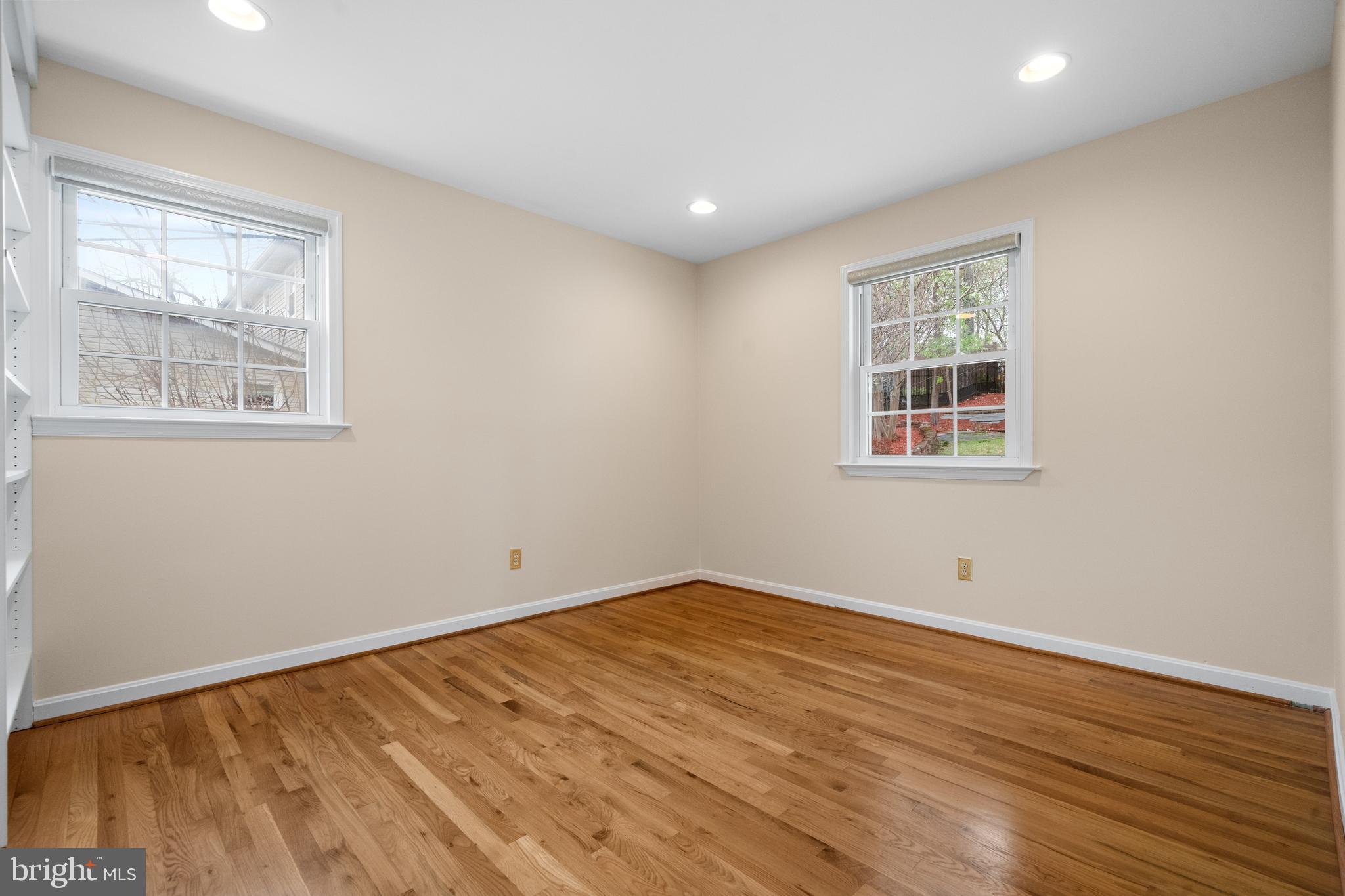6119 Greeley Boulevard Springfield, VA 22152 - Photo 15 of 38 a view of empty room with wooden floor and fan