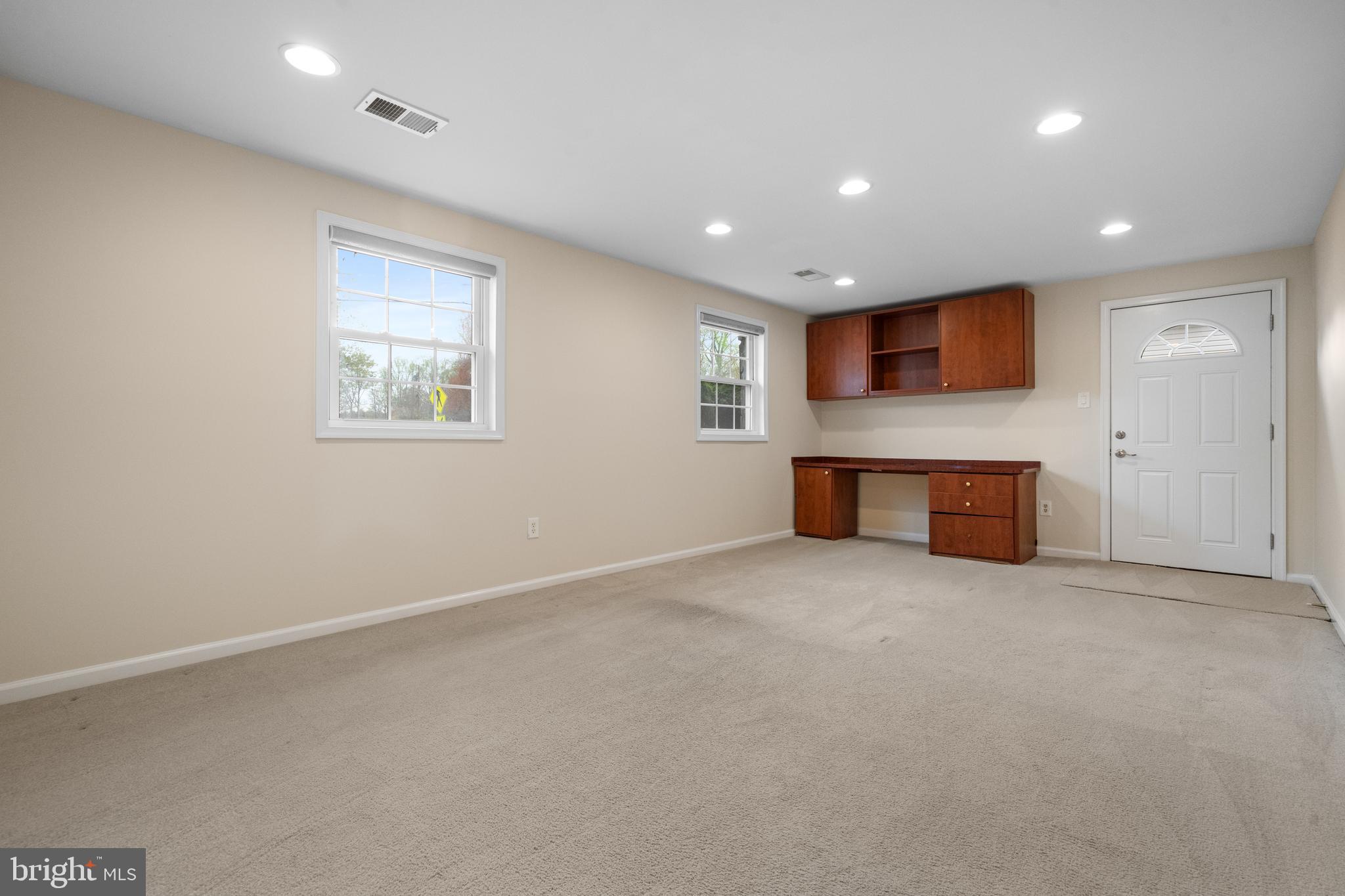 6119 Greeley Boulevard Springfield, VA 22152 - Photo 25 of 38 an empty room with a fireplace and cabinet