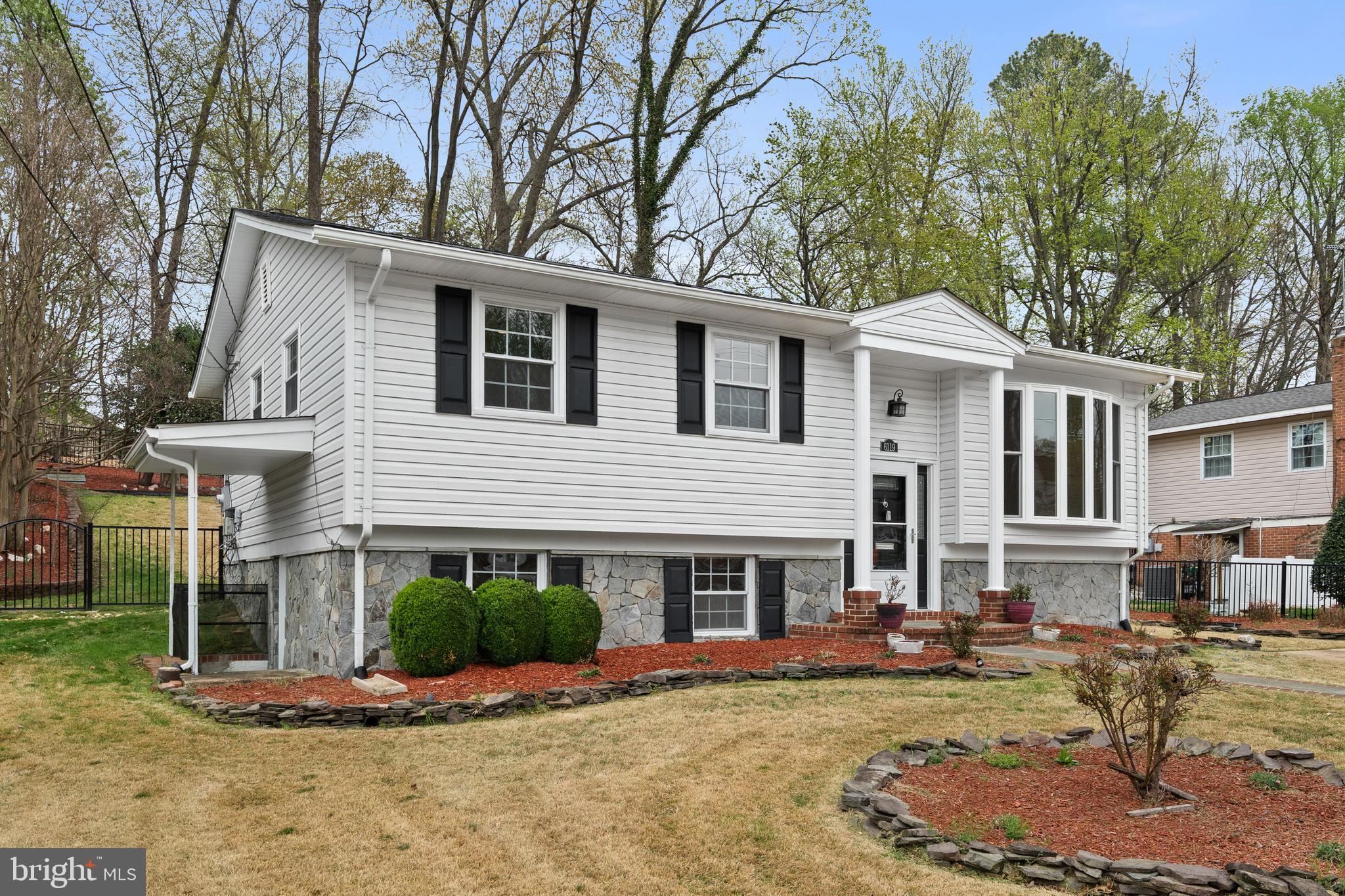 6119 Greeley Boulevard Springfield, VA 22152 - Photo 3 of 38 a front view of a house with garden