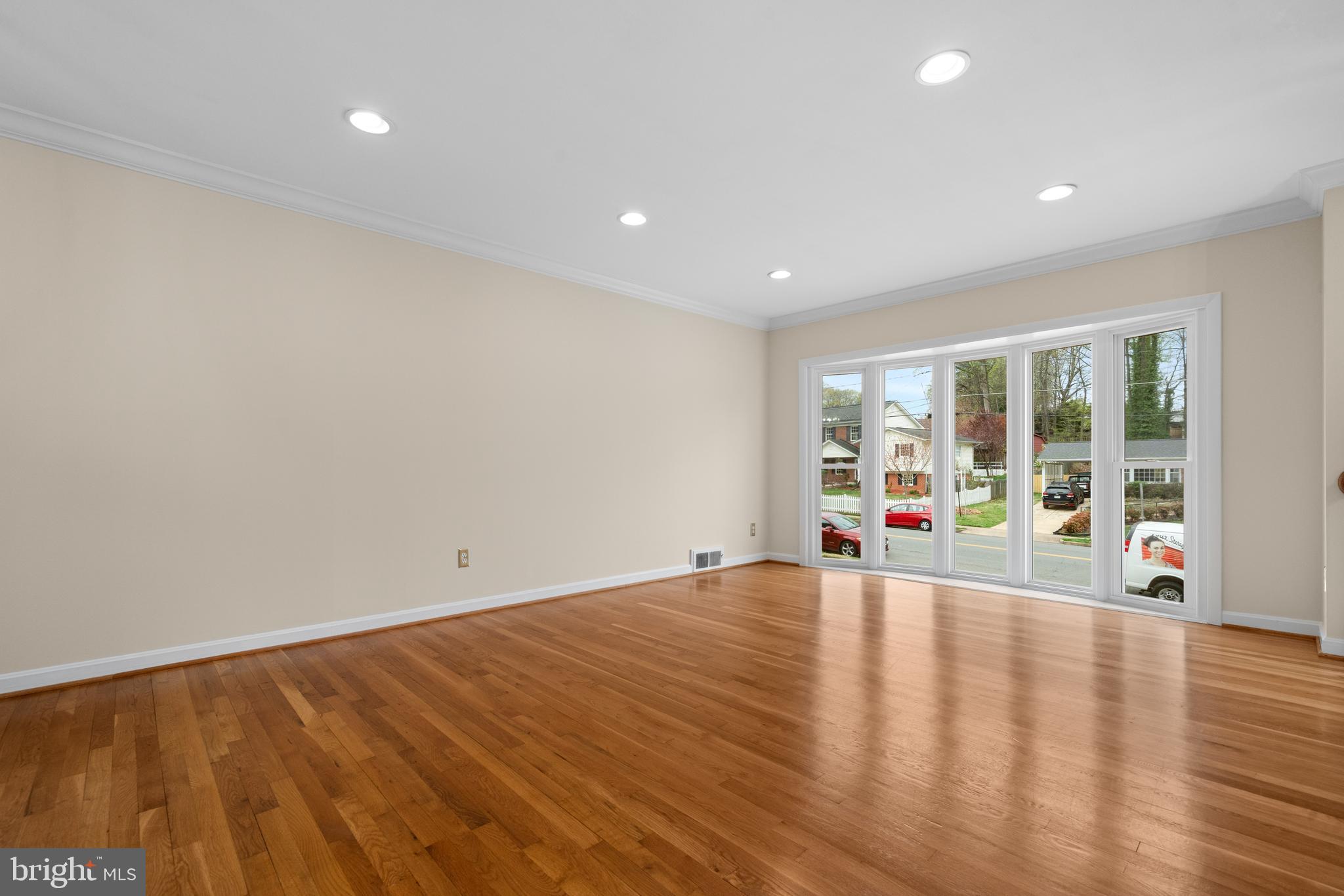 6119 Greeley Boulevard Springfield, VA 22152 - Photo 4 of 38 a view of an empty room with wooden floor and a window