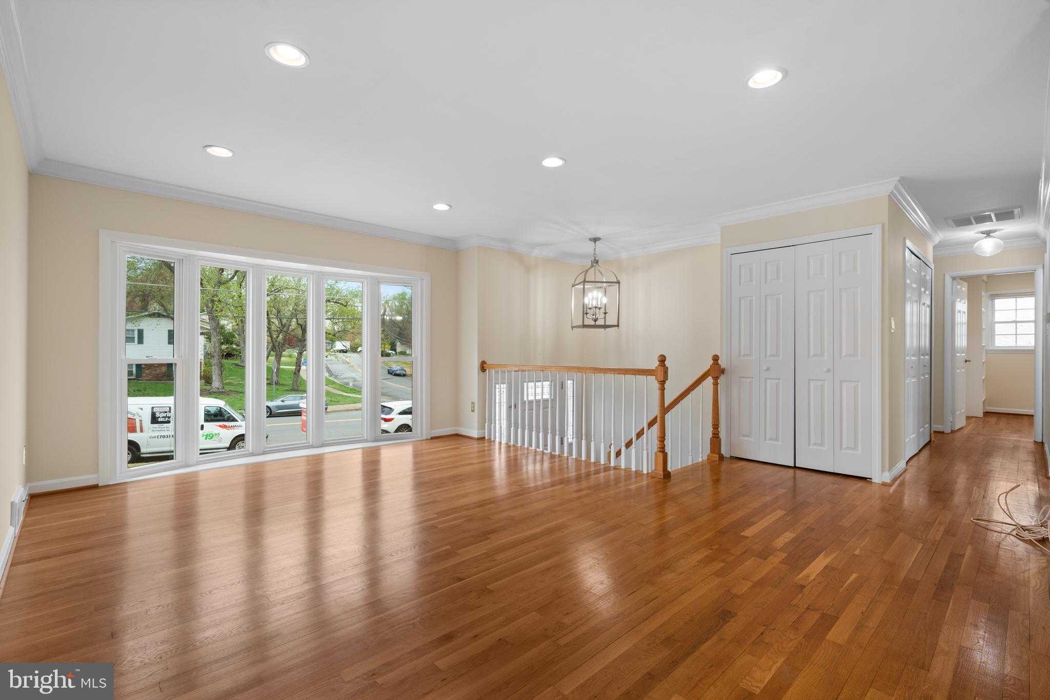 6119 Greeley Boulevard Springfield, VA 22152 - Photo 8 of 38 a view of an empty room with wooden floor and a window