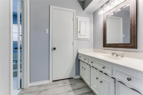 a bathroom with a double vanity sink and mirror