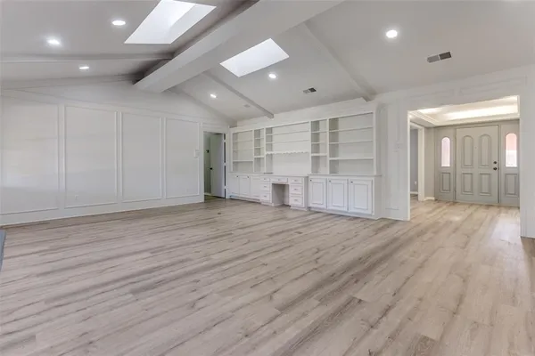 an empty room with wooden floor