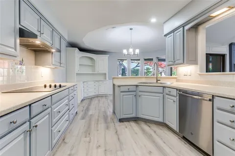 a kitchen with a sink stove and cabinets
