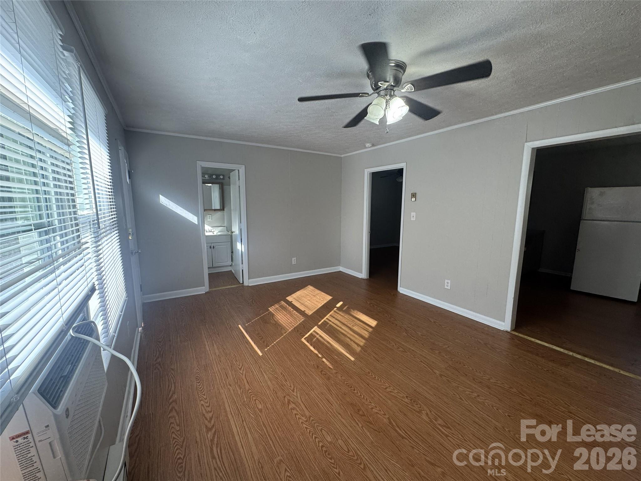 341 Laurel Street Hudson, NC 28638 - Photo 2 of 8 a view of a livingroom with a ceiling fan and window