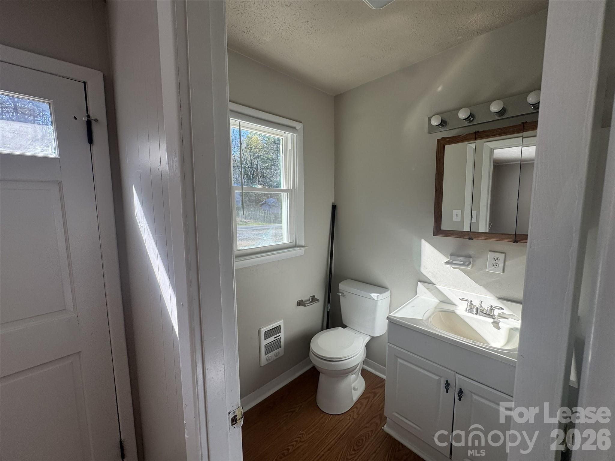 341 Laurel Street Hudson, NC 28638 - Photo 6 of 8 a bathroom with a toilet sink and mirror