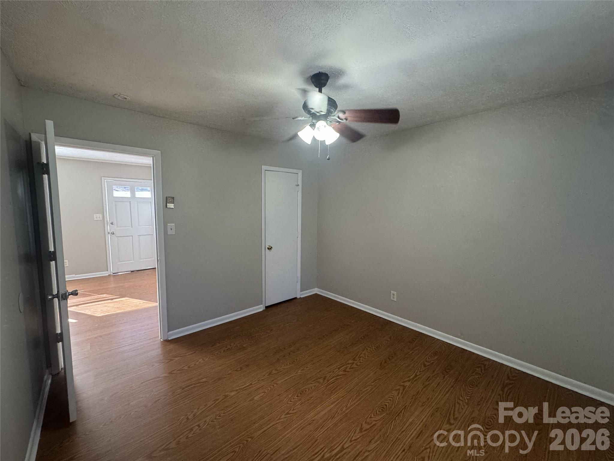 341 Laurel Street Hudson, NC 28638 - Photo 7 of 8 an empty room with closet and a chandelier fan
