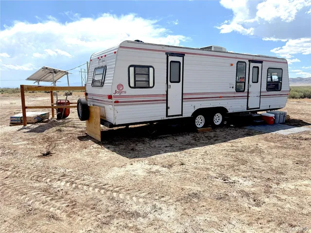 a room with stainless steel appliances kitchen island granite countertop a sink and wooden cabinets